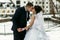 The brides kissing near frozen lake