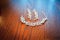 Brides white earrings and bracelet laying on the brown table