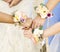Bridesmaid hands and bride corsages