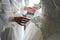 Bridesmaid holding bride`s wedding dress