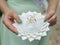 Bridesmaid holds ring pillow with pair golden wedding rings