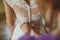Bridesmaid makes bow-knot on the back of brides wedding dress.