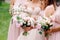 Bridesmaid`s bouquets, wedding bouquets closeup. Stylish summer wedding. Contemporary fashion wedding trends.