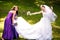 Bridesmaids help bride to put on earrings and necklace