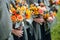 Bridesmaids holding their wedding bouquets of flowers with yellow, red, blue and orange flowers