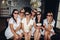 Bridesmaids and pretty bride in glasses eating popcorn