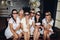 Bridesmaids and pretty bride in glasses eating popcorn