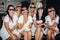 Bridesmaids and pretty bride in glasses eating popcorn