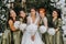 Bridesmaids smiling together with the bride. The bride and her fun friends celebrate the wedding after the ceremony