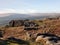 Bridestones moor in west yorkshire with gritstone outcrops surrounded by hills on a sunny day