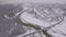 Bridge across a frozen river in winter in a small town near the forest