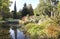 Bridge across the river in park, perspective view.