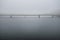 Bridge in calm peaceful misty weather in white dreamy landscape