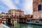 Bridge, Channel with boats and historic buildings on embankment. Fondamenta del Abbazia. Venice, Veneto, Italy.