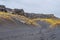 Bridge between continents in Iceland black sand forming dunes