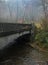 A bridge crosses a stream in the Blue Ridge Mountains on a foggy day