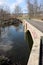 The bridge crosses the stream is this rural park.