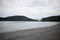 Bridge deception Pass bridge and distance on beach overcast day sand rocky sandy