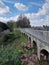 Bridge extending across a tranquil path in a park