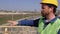 On the bridge is a foreman with a beard and mustache in a yellow helmet and gives instructions. 4k videoa foreman with a beard and