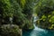 Bridge of God Waterfalls San Luis PotosÃ­ - January 19, 2020: beautiful woman on a rock watching the waterfall and the turquoise