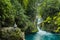 Bridge of God Waterfalls San Luis PotosÃ­ - January 19, 2020: beautiful woman on a rock watching the waterfall and the turquoise