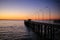 Bridge hanging over the sea with lights during sunset