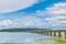 The bridge of Her Majesty Thepsuda,Lam Pao Dam,Kalasin province,Thailand with the beautiful blue sky and cloud.