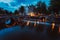 Bridge illumination and boat light trails in evening Amsterdam with reflection in Herengracht canal. Typical dutch