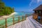 Bridge leading to overwater bungalow in blue lagoon