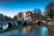 A bridge with lights and boat streaks over the Keizersgracht Canal