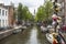 Bridge with love padlocks on typical canal in Amsterdam