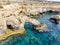 Bridge of Lovers rock formation on the rocky shore of the Mediterranean sea on the island of Cyprus Ayia NAPA. Tourists walk along