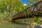 Bridge with metal guardrails over the glistening water at Ogden River Parkway