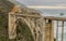 Bridge next to Pacific Ocean - mountains in the background - on highway 1 california usa