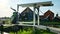 Bridge over canal at windmills at Zaanse Schans in Holland. Zaandam, Netherlands