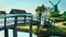 Bridge over canal at windmills at Zaanse Schans in Holland. Zaandam, Netherlands