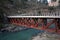 Bridge over deep green river Beas in remote rural