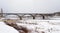 Bridge over the frozen Volga River in Staritsa, overcast winter