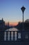 Bridge over isar river munich, with old lantern, at sunset