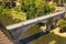 Bridge over Ohre River to medieval part of Loket town. Little boat for tourist trips under the bridge.