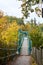 Bridge over the river. Bridge in the forest. Crossing the water in the countryside. Metal bridge for people in rural areas through