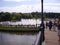 Bridge over the river and fountains in the Moscow park. Walking townspeople.