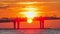 Bridge over river lit by orange setting sun light timelapse