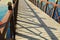 Bridge over the river in a park concrete floor wooden rail blue sky reflects down the river