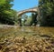 A bridge over river with rocks underwater