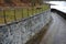 Bridge over safety spillway of the dam. stone bridge with natural paving of gray flat stones. on the edge of the retaining walls i