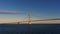 The bridge over the sea on which the transport goes. Morning. The sun beautifully illuminates the bridge. View from the bridge of