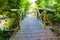 The bridge over the stream with railings of logs