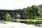 Bridge over the Tozo river full of Ranunculus aquatilis or aquatic buttercup is a species belonging to the Ranunculaceae family